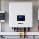 Wall-mounted solar inverter with a DC isolator switch and AC breaker box, showing the main electrical components of a rooftop solar system
